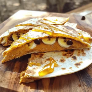 - 2 large flour tortillas - 1/2 cup creamy peanut butter - 1 ripe banana, sliced - 1 tablespoon honey - 1/4 teaspoon cinnamon - 1/4 cup mini chocolate chips (optional) - Cooking spray or butter, for grilling To make a tasty peanut butter quesadilla, gather these simple ingredients. You need two large flour tortillas, which hold everything together. A creamy peanut butter brings rich flavor and smooth texture. The ripe banana adds natural sweetness and creaminess. Next, you can enhance the flavor with honey, which gives a nice touch of sweetness. A sprinkle of cinnamon adds warmth and depth. If you want a little fun, mini chocolate chips can add a sweet crunch. Finally, don’t forget about cooking essentials! Use cooking spray or butter to keep your quesadilla from sticking to the skillet. This mix of ingredients creates a delicious meal or snack that is quick and easy to make. For the full recipe, check out the Peanut Butter Quesadilla section. First, gather all your ingredients and tools. You will need: - 2 large flour tortillas - 1/2 cup creamy peanut butter - 1 ripe banana, sliced - 1 tablespoon honey - 1/4 teaspoon cinnamon - Cooking spray or butter for grilling Next, slice the banana into thin rounds. Measure out the peanut butter and set everything aside. Now, take one tortilla and spread the peanut butter evenly on one side. Make sure it's nice and thick. Next, layer the banana slices over the peanut butter. This adds sweetness and great taste. Drizzle honey over the bananas and sprinkle with cinnamon. If you like chocolate, add mini chocolate chips at this stage. Take the second tortilla and place it on top, peanut butter side down. This forms your quesadilla. Preheat your skillet over medium heat. Once hot, lightly coat it with cooking spray or butter. Carefully place the quesadilla in the skillet. Cook for about 3-4 minutes until the bottom is crispy and golden brown. Then, flip the quesadilla using a spatula. Cook for another 3-4 minutes until the other side is browned as well. After cooking, let it cool for a minute. Slice it into wedges and enjoy! For the Full Recipe, check the earlier section. To make the best peanut butter quesadilla, choose the right tortillas. I like to use large flour tortillas. They are soft and fold well. You can also try whole wheat for a healthy twist. They add a nutty flavor. When spreading peanut butter, use a spatula or a knife. Start at the center and spread outwards to the edges. This helps you cover the entire tortilla. Make sure it’s even. A good spread means every bite is tasty. You can add fun ingredients to boost flavor. Try mixing in sliced strawberries, apples, or even a handful of nuts. These add crunch and freshness. For a sweeter touch, honey works wonders. Drizzle honey on top of the banana. This adds a nice sweetness without overpowering the dish. Serving your quesadilla in a fun way makes it special. Cut the quesadilla into triangles. Arrange the pieces like a star on a plate. You can also add a dollop of yogurt or whipped cream on the side. Pair your quesadilla with fruits like apple slices or berries. You can even serve it with chocolate sauce for dipping. It turns a simple meal into a fun treat. Check out the Full Recipe for more tips! {{image_2}} If you want to try something different, swap peanut butter for almond butter or cashew butter. These options offer unique tastes. They also provide great health benefits. For those with nut allergies, you can use sunflower seed butter or soy nut butter. These choices let everyone enjoy this tasty treat without worry. Add fruits or nuts to boost flavor and texture. Sliced strawberries or apples can brighten your quesadilla. You can also sprinkle in chopped nuts for crunch. If you like bold flavors, try adding a dash of cinnamon or a pinch of nutmeg. These spices give your quesadilla a warm touch. You can cook your quesadilla in different ways. Grilling gives a crispy texture, while baking is simple and hands-off. If you want to try something fun, use a waffle maker. It adds cool shapes and a unique texture. Just remember to spray it lightly with oil to prevent sticking. For more details, check the Full Recipe. Store your leftover peanut butter quesadilla in an airtight container. This helps keep it fresh. You can refrigerate it for up to three days. Just remember, the longer it sits, the softer it gets. To reheat your quesadilla, use a skillet over medium heat. This method keeps it crispy. Heat it for about two minutes on each side. You can also use a microwave, but this may make it chewy. If you use the microwave, place a paper towel under it to soak up moisture. Yes, you can freeze peanut butter quesadillas! Wrap each quesadilla in plastic wrap. Then place them in a freezer bag. They can stay in the freezer for up to two months. When you're ready to eat, thaw it in the fridge overnight. Reheat in a skillet for the best texture. Enjoy your tasty treat anytime! For the full recipe, see above. Yes, you can use whole wheat tortillas. Whole wheat tortillas add fiber and nutrients. They can make your quesadilla more filling. Plus, they have a nutty flavor that pairs well with peanut butter. Whole wheat options provide a healthier twist. They also contain less processed ingredients than regular tortillas. Absolutely! This recipe is kid-friendly and fun. Kids often love peanut butter and bananas. The sweetness makes it appealing to young taste buds. You can involve kids in making them too. They can help spread the peanut butter and layer the bananas. It's a great way to teach them cooking skills. A peanut butter quesadilla has about 400 calories. This can vary based on the ingredients. Here’s a breakdown of the main components: - Flour tortillas: Around 200 calories total for two - Peanut butter: About 400 calories for 1/2 cup - Banana: Roughly 100 calories for one medium banana - Honey: Around 64 calories for one tablespoon When you combine these, the total is around 400 calories. You can reduce calories by using less peanut butter or honey. This blog post shared a fun recipe for peanut butter quesadillas. You learned about the right ingredients and how to make them. We covered cooking tips and storage advice for leftovers too. These quesadillas are simple and tasty for everyone. Feel free to experiment with flavors and ingredients. Enjoy making this treat that is easy and fun to eat!