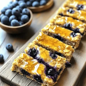 To make these tasty bars, you need a few key ingredients: - 2 cups rolled oats - 1 cup almond milk (or any milk of choice) - 1 cup fresh or frozen blueberries Rolled oats form the base of these bars. They're great for giving texture and nutrients. Almond milk adds moisture without strong flavors. You can also use any milk you prefer. Blueberries bring natural sweetness and color to the bars. For sweetness and flavor, gather: - 1/4 cup honey or maple syrup - 1/4 cup natural peanut butter (or almond butter) - Optional: 1/4 cup chopped nuts or seeds (e.g., walnuts, chia seeds) Honey or maple syrup adds a touch of sweetness. Natural nut butter gives richness and healthy fats. You can add nuts or seeds for crunch and extra nutrients. They make the bars more filling and fun to eat. To enhance the flavor, gather these spices: - 1/2 teaspoon ground cinnamon - 1 teaspoon baking powder - Pinch of salt - 1/2 teaspoon vanilla extract Ground cinnamon adds warmth and depth. Baking powder helps the bars rise. A pinch of salt balances the sweetness. Finally, vanilla extract gives a lovely aroma and taste. These ingredients make the bars healthy and delicious. For the full recipe, check the section below. Start by preheating your oven to 350°F (175°C). This step is key to getting those bars just right. Next, grab a 9x9 inch baking dish. Line it with parchment paper. This helps with easy removal later. Now, in a large mixing bowl, add your dry ingredients. Combine 2 cups of rolled oats, 1 teaspoon of baking powder, 1/2 teaspoon of cinnamon, and a pinch of salt. Mix them well. This blend sets the flavor for your bars. In a separate bowl, whisk together the wet ingredients. Pour in 1 cup of almond milk, add 1/4 cup of honey or maple syrup, and 1/4 cup of peanut butter. Don’t forget 1/2 teaspoon of vanilla extract. Stir until it is smooth and creamy. Now, pour the wet mix into the dry oats. Stir them together until fully combined. This is where magic happens! Gently fold in 1 cup of blueberries. If you want to, you can add 1/4 cup of chopped nuts or seeds for extra crunch. Pour the mixture into your prepared baking dish. Spread it evenly and press it down gently. This helps the bars hold together. Bake in the preheated oven for about 25 to 30 minutes. Check for doneness by looking for golden edges. After baking, let the bars cool in the pan for 10 minutes. Then lift them out using the parchment paper. Place them on a wire rack to cool completely. Once cool, slice them into bars. You can store them in an airtight container for up to a week. Enjoy your Blueberry Oatmeal Breakfast Bars! For the full recipe, click [Full Recipe]. To get the best Blueberry Oatmeal Breakfast Bars, start by ensuring even baking. This helps achieve a nice texture. Spread the mixture flat in the pan and press it down gently. This will give you a uniform bake. You can also adjust the sweetness to fit your taste. If you like it sweeter, add more honey or maple syrup. For a less sweet bar, use less. Taste the mixture before baking to find your perfect balance. One mistake is overmixing the batter. This can make the bars tough. Mix just until everything is combined. Another common error is not letting the bars cool completely. If you cut them too soon, they may fall apart. Let them cool in the pan for about 10 minutes, then cool fully on a wire rack. This helps them firm up. Serve these bars with yogurt for extra creaminess. You can also add fresh fruit on top for a burst of flavor. They are perfect for breakfast or as snacks on the go. You can pack them for school or work. Enjoy these bars anytime you need a quick, healthy bite. For the full recipe, check out the Blueberry Oatmeal Breakfast Bars recipe! {{image_2}} You can change fruits in these bars. Try raspberries or chopped apples. These fruits add new flavors and textures. You can also swap honey for agave syrup or stevia. These options work well if you want less sugar. Each change keeps the bars tasty and healthy. If you're gluten-free, use certified gluten-free oats. This keeps the bars safe for your diet. You can also make these bars vegan. Just skip the nut butter. Instead, use mashed bananas or applesauce. Both add moisture and flavor without any animal products. Want to make the bars even better? Add chocolate chips or coconut flakes. Both give a sweet, fun twist. Infusing the bars with citrus zest also brightens the flavor. A little lemon or orange zest makes a big difference. Each of these ideas helps you create a snack you'll love. For the full recipe, check out the detailed instructions above. To keep your Blueberry Oatmeal Breakfast Bars fresh, use an airtight container. This helps seal in moisture and flavor. These bars stay tasty for up to one week in the fridge. If you want to keep them longer, freezing works great. To freeze your breakfast bars, let them cool completely. Slice them into bars and wrap each one tightly in plastic wrap. Place the wrapped bars in a freezer-safe bag. They can last up to three months in the freezer. When you are ready to eat, just take one out and thaw it at room temperature. For the best texture, avoid using the microwave. To reheat your bars, place them in the oven at 350°F for about 10 minutes. This warms them up nicely without drying them out. You can also use a toaster oven for a quick warm-up. Serve the warmed bars with yogurt or fresh fruit for an extra tasty treat. For the full recipe, check out the detailed instructions above. Yes, you can make these bars ahead of time. I often prepare a batch on the weekend. Once they cool, store them in an airtight container. Keep them in the fridge for up to a week. This way, you always have a tasty snack ready to go. If you need a milk substitute, try regular cow's milk or soy milk. Coconut milk is also a great option. For a nut-free choice, oat milk works well. Each option gives a nice flavor and texture to the bars. Most oats are safe for gluten-free diets. However, ensure you use certified gluten-free oats. This helps avoid cross-contamination. Always check the label to be sure. With the right oats, these bars can be enjoyed by everyone. These breakfast bars last about a week when stored correctly. Look for signs like a dry or hard texture. If they smell off, it's best to toss them. Enjoy them fresh for the best taste! Yes, adding protein powder boosts the bars' nutrition. Start with one scoop and mix it into the dry ingredients. Adjust the liquid slightly if the mix feels too dry. This way, you keep the bars moist and tasty. For the full recipe, check out the section above. Blueberry oatmeal breakfast bars are a simple and tasty treat. We covered the key ingredients, like oats, almond milk, and blueberries. I gave you clear steps to mix and bake, along with essential tips to avoid mistakes. You can try different fruits and make it fit your diet too. Store them right to keep them fresh, and they’re perfect for breakfast or snacks. These bars can be made ahead, so you always have a healthy option. Enjoy your baking and get creative with your flavors!