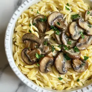 - 1 cup orzo pasta - 2 cups vegetable broth - 1 cup mushrooms (cremini or button), sliced - 1 small onion, finely chopped - 2 cloves garlic, minced - 1 teaspoon dried thyme - ½ teaspoon black pepper - Salt to taste - ½ cup heavy cream (or coconut cream for a dairy-free version) - ¼ cup grated Parmesan cheese (omit for a vegan version) - Fresh parsley, chopped (for garnish) I love the simplicity of this dish. The main ingredient, orzo pasta, makes it special. Orzo is small, rice-shaped pasta that cooks quickly. The vegetable broth brings a rich flavor to the pasta. I recommend using fresh mushrooms, either cremini or button. They add a great texture and taste. For aromatics, I always use fresh onion and garlic. They create a wonderful base for the dish. Dried thyme gives a lovely earthy note. Black pepper and salt help enhance all the flavors. The creamy elements are what make this dish truly dreamy. Heavy cream adds richness, but coconut cream works well for a dairy-free option. Don’t forget the Parmesan cheese! It melts perfectly and adds depth. Finally, fresh parsley brightens the plate and gives a burst of color. In just a few steps, you will create a comforting and satisfying meal. {{ingredient_image_1}} 1. Boil the Vegetable Broth: In a medium saucepan, bring 2 cups of vegetable broth to a boil. 2. Cook the Orzo: Add 1 cup of orzo pasta to the broth. Cook it for 8 to 10 minutes. The orzo should be al dente. 3. Drain and Set Aside: Once cooked, drain the orzo and set it aside for later. 1. Sauté the Onion: In a large skillet, heat 1 tablespoon of olive oil over medium heat. Add 1 small, finely chopped onion. Sauté it until it turns translucent, about 3 to 4 minutes. 2. Add Garlic and Mushrooms: Next, stir in 2 minced garlic cloves and 1 cup of sliced mushrooms. Cook this mixture for 5 to 7 minutes until the mushrooms become tender and brown. 1. Season the Mixture: Add 1 teaspoon of dried thyme, ½ teaspoon of black pepper, and salt to taste. Stir well to combine. 2. Incorporate Heavy Cream: Lower the heat and pour in ½ cup of heavy cream. Mix thoroughly until the cream heats through. 3. Combine with Orzo: Add the cooked orzo to the skillet with the creamy mushroom sauce. Stir until the orzo is well coated. If it's too thick, add a splash of vegetable broth to reach your desired creaminess. This process makes a rich, creamy dish that feels warm and comforting. Enjoy the blend of flavors as they come together! To cook orzo al dente, start with boiling vegetable broth. After it boils, add the orzo. Cook it for 8-10 minutes. Check the package for exact times. You want the orzo firm but not hard. Drain it well and set it aside. For creaminess, add vegetable broth to your sauce. If your dish feels too thick, just pour in a splash. This will help reach your desired texture. Fresh herbs add great taste. Try adding chopped parsley or thyme. They brighten up the dish. You can also use a pinch of red pepper flakes for heat. This little kick can make it pop. To complement the flavors, think about adding a squeeze of lemon juice. It balances the cream and mushrooms beautifully. Serve the creamy orzo in shallow bowls. This makes it look inviting. Top with extra grated Parmesan for richness. A sprinkle of fresh parsley adds color and freshness. It makes the dish more vibrant and appealing. Pro Tips Use Fresh Herbs: Fresh thyme can elevate the flavor of your dish significantly. If available, opt for fresh herbs over dried for a more vibrant taste. Cooking Orzo: Make sure to stir the orzo occasionally while cooking to prevent it from sticking together. This ensures a nice, fluffy texture. Adjust Creaminess: If you prefer a lighter dish, you can substitute part of the heavy cream with vegetable broth or a splash of white wine for added depth without the heaviness. Perfect Mushroom Sauté: Allow the mushrooms to brown properly in the skillet without overcrowding them. This will enhance their flavor and texture, making them more delicious. {{image_2}} You can make a vegan version of creamy mushroom orzo. For this, swap heavy cream for coconut cream. This change keeps the dish rich and creamy without dairy. Omit the Parmesan cheese to maintain the vegan aspect. This will still provide a satisfying taste and texture, allowing everyone to enjoy it. Want to boost the protein? Try adding grilled chicken or sautéed shrimp. Cook the protein separately and mix it in at the end. This addition makes the dish more filling and adds a new layer of flavor. You can also season the protein to match the orzo, enhancing the overall taste. Feel free to get creative with vegetables. You can add spinach or peas for extra color and nutrition. Simply toss them in during the last few minutes of cooking. This will keep the veggies bright and tender. Other veggies like bell peppers or zucchini also work well, making the dish even more vibrant and healthy. To keep your Creamy Mushroom Orzo fresh, store it in an airtight container. Make sure it cools down before sealing. This way, it won’t trap steam and get soggy. It lasts about 3 to 4 days in the fridge. Always check for any changes in smell or color before eating. When reheating creamy orzo, use low heat. This helps keep the texture smooth. You can add a splash of vegetable broth or cream to make it creamy again. Stir often to heat evenly. A microwave works too; just cover it to prevent drying out. You can freeze Creamy Mushroom Orzo! Portion it out in airtight containers. It stays good for about 2 to 3 months. To thaw, place it in the fridge overnight. Reheat on the stove or microwave, adding a little broth if needed. This keeps the dish creamy and tasty. To make Creamy Mushroom Orzo gluten-free, I suggest using gluten-free orzo pasta. This type cooks just like regular orzo. You can also check if your vegetable broth is gluten-free. Some brands may include gluten. Always read the labels carefully. This way, you can enjoy the same creamy flavor without worry. Yes, you can use various mushrooms in this dish. Cremini and button mushrooms are great options. They add a mild, earthy flavor. If you want bolder tastes, try shiitake or portobello mushrooms. These mushrooms have a deeper flavor that brings more depth to the dish. Mixing different types can also create a unique taste and texture. To make more servings of Creamy Mushroom Orzo, simply double or triple the ingredients. For example, use 2 cups of orzo and 4 cups of broth for eight servings. Keep the cooking times similar. You may need a larger pot to hold everything. Just make sure to stir well to combine all the flavors. In this blog post, we explored how to make a delicious Creamy Mushroom Orzo. We covered key ingredients, from orzo and broth to aromatics and creamy elements. I shared step-by-step cooking instructions and helpful tips for perfect texture and flavor. You can adapt this recipe for vegan options and add protein or veggies to suit your taste. Remember to store leftovers properly for later enjoyment. With these easy steps and tips, you will create a dish that delights everyone. Enjoy your cooking adventure!