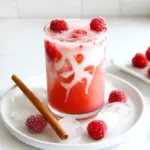 - 2 cups water - 2 black tea bags - 1 teaspoon vanilla extract - 1 tablespoon honey or maple syrup - 1/2 cup fresh raspberries (plus extra for garnish) - 1 cup milk (dairy or non-dairy) - Ice cubes - Optional: Cinnamon stick for garnish In this refreshing iced raspberry vanilla chai, each ingredient plays a big role. We start with water, which is the base of our drink. The black tea bags add a rich flavor. Vanilla extract gives it warmth and sweetness. Honey or maple syrup adds a touch of natural sweetness. Fresh raspberries bring a fruity twist and vibrant color. Milk, whether dairy or non-dairy, makes the drink creamy. Ice cubes chill the drink, making it perfect for hot days. Lastly, a cinnamon stick adds a nice touch if you want to get fancy. Using fresh, quality ingredients helps your drink taste its best. You can pick your favorite milk to make it your own. Enjoy the blend of flavors and the cooling sensation this drink offers. First, grab a saucepan. Pour in 2 cups of water. Set the heat to high and bring it to a boil. This step is quick and easy. While the water heats, prepare your black tea bags. Once the water boils, remove it from the heat. Add your 2 black tea bags to the hot water. Let them steep for about 5 minutes. This time allows the tea to develop a rich flavor. After 5 minutes, take out the tea bags and discard them. While the tea is still warm, stir in 1 teaspoon of vanilla extract. Next, add 1 tablespoon of honey or maple syrup. Mix well until the sweetener dissolves completely. Now, let's add the raspberries. Take 1/2 cup of fresh raspberries and place them in the tea mixture. Use a fork to mash them gently. This releases their juices, which adds a fruity taste. The mixture should look vibrant and colorful. Now, let the tea cool to room temperature. After that, place it in the fridge for about 30 minutes. You want it chilled before serving. Once the tea is cold, strain it through a fine sieve or cheesecloth. This step removes the raspberry pulp and gives you a smooth drink. To serve, fill a glass halfway with ice cubes. Pour the chilled raspberry vanilla chai over the ice. Top it off with 1 cup of milk. You can use dairy or non-dairy milk based on your taste. Stir gently to mix. For a nice touch, garnish with a few fresh raspberries on top and a cinnamon stick if you like. Enjoy your refreshing summer drink! To get the best flavor from your chai, steep the tea bags for 5 minutes. This time lets the tea release its rich taste. If you steep too long, the tea can get bitter. When it comes to sweetness, start with one tablespoon of honey or maple syrup. After mixing, taste it. If you want it sweeter, add more. Adjusting the sweetness helps match your personal taste. You can choose between dairy and non-dairy milk. Almond, oat, or soy milk all work well. Each adds its own unique flavor. If you want a creamier drink, use whole milk or cream. For extra flavor, think about adding a pinch of nutmeg or a dash of cardamom. You can also blend in a bit of fresh mint or top with whipped cream. These small touches can elevate your iced raspberry vanilla chai. {{image_2}} You can switch up your sweetener in this iced raspberry vanilla chai. Instead of honey or maple syrup, try agave syrup. Agave syrup is sweeter, so use less. This works well if you want a low-glycemic option. Stevia is another great choice. It has no calories and adds sweetness without sugar. You can also think about using herbal teas for flavor. For example, a chamomile tea bag can add a soft, floral note. If you like mint, try a peppermint tea bag. Each tea brings a new twist to your drink, making it fun to experiment. Seasonal fruits can make your iced chai even better. In the summer, add slices of peaches or strawberries for a fresh taste. In fall, try adding apple slices and a pinch of nutmeg. Each season brings new flavors to enjoy. You can also create iced chai variations for different flavors. For a spiced chai, add a few whole cloves or cardamom pods while steeping the tea. This gives a warm, cozy feel. For a tropical vibe, add coconut milk instead of regular milk. This will transport you to a beach with every sip! To keep your iced raspberry vanilla chai fresh, choose a glass jar with a tight lid. This helps preserve its flavor. The chai can last in the fridge for about three days. After that, the taste may fade. Always check for any off smells or changes in color before drinking. If you want to enjoy your chai again, you can warm it up. Heat it gently in a saucepan over low heat. Stir it often to prevent burning. If you want a fun twist, consider using leftover chai in smoothies. Blend it with ice, yogurt, and extra berries for a tasty treat. You can also pour it over desserts like ice cream or yogurt for a refreshing flavor boost. Yes, you can! While black tea gives a strong flavor, you can try green tea or herbal tea. Each type will change the taste a bit. For example, chai with green tea is lighter and fresher. Herbal teas can add unique flavors, like chamomile or peppermint. Experiment to find what you like best! Absolutely! To make this drink vegan, just swap out dairy milk for any non-dairy alternative. Almond, oat, or coconut milk all work great. Also, use maple syrup instead of honey, as honey is not vegan. This keeps the drink tasty and friendly for all diets. To boost the raspberry flavor, use more fresh raspberries in the drink. You can also add raspberry puree for a stronger taste. If you want a fun twist, try adding raspberry extract. This small addition packs a punch and makes the drink even more delightful! This blog post gave you a simple way to make delicious raspberry chai. We covered the key ingredients, step-by-step steps, and useful tips. Customization ideas and storage tips ensure this drink fits your needs. With these insights, you can enjoy your chai hot or iced, year-round. Try experimenting with flavors and sweeteners to find your perfect blend. Enjoy this drink's warmth and flavor anytime!